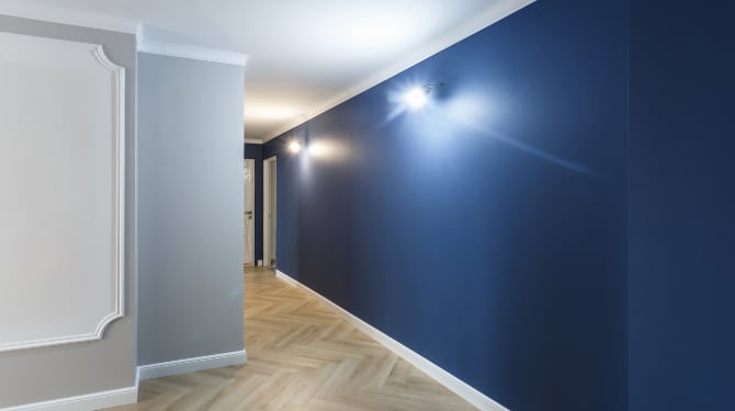 Hallway interior where the walls painted white, gray and blue color and white color ceilings