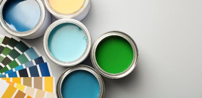 Paint cans and color palette on grey background